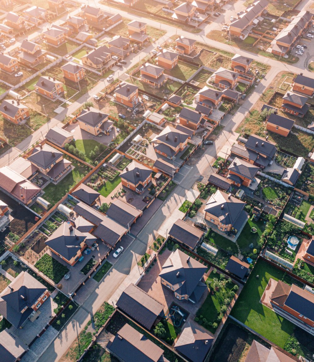 Aerial view of a luxurious village with smooth rows of two-storey duplex houses. Neighborhood in the area and real estate investments.