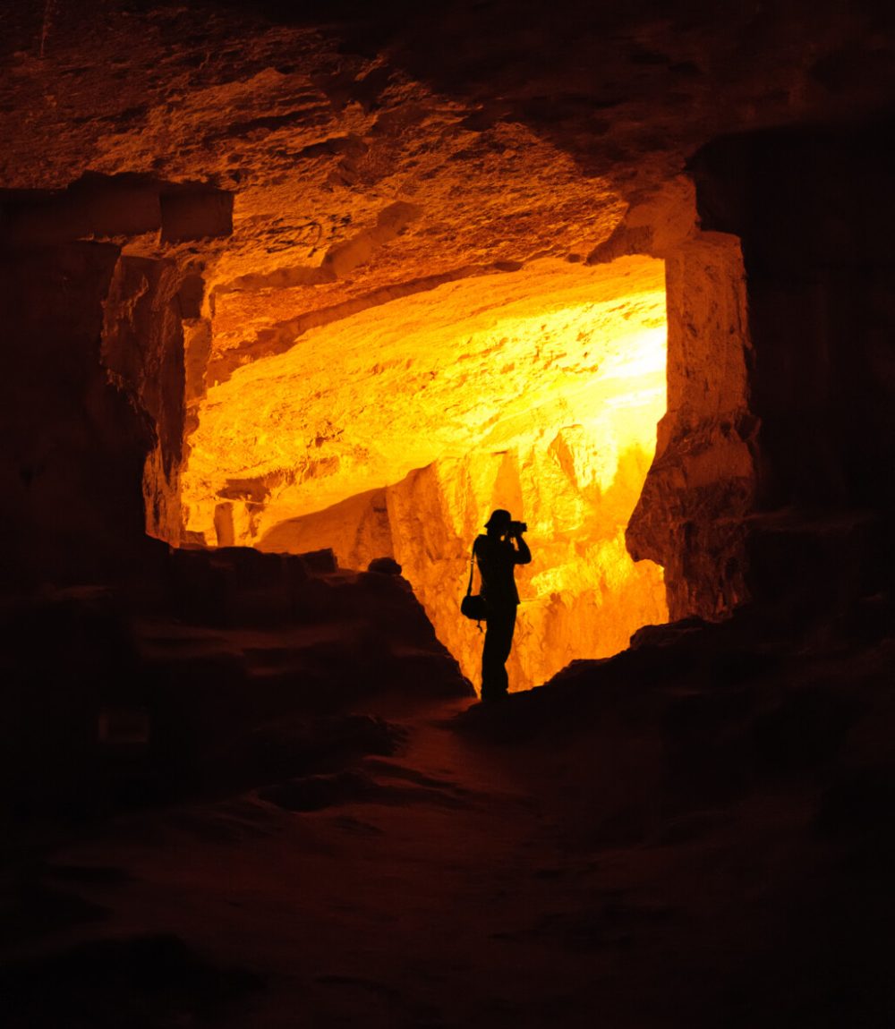 Silhouette of photographer taking photo in a cave (King Solomon Quarries a.k.a. ZedekiahÕs Cave in Jerusalem, Israel)